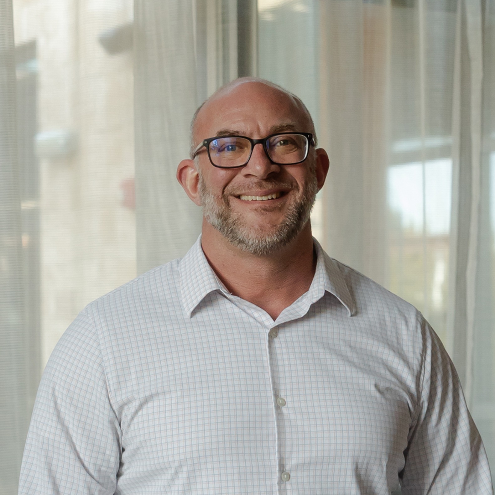dr-christoipher-sq Male orthodontist wearing glasses smiling in office at Walla Walla Orthodontics